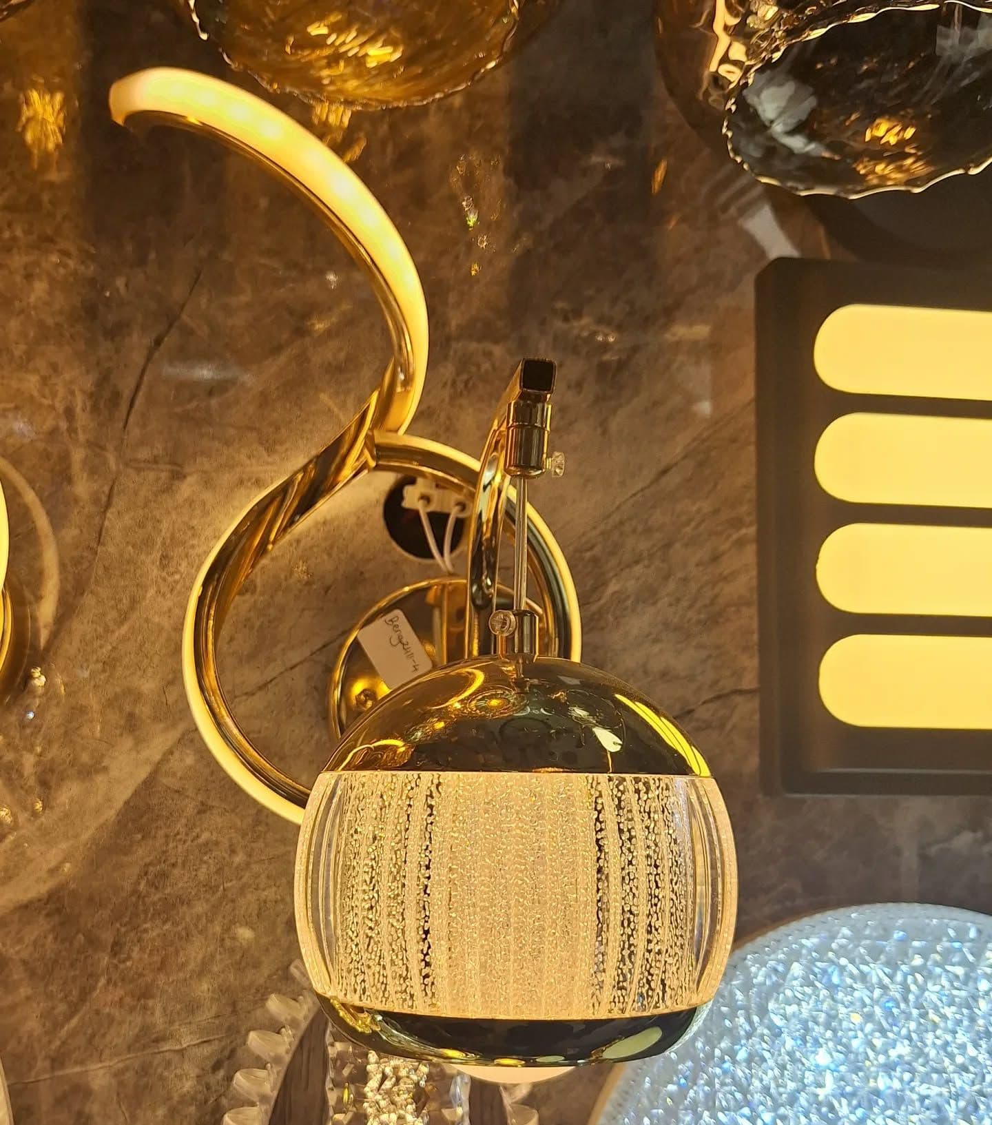 Modern Gold Swirl LED Wall Light with Frosted Glass Globe